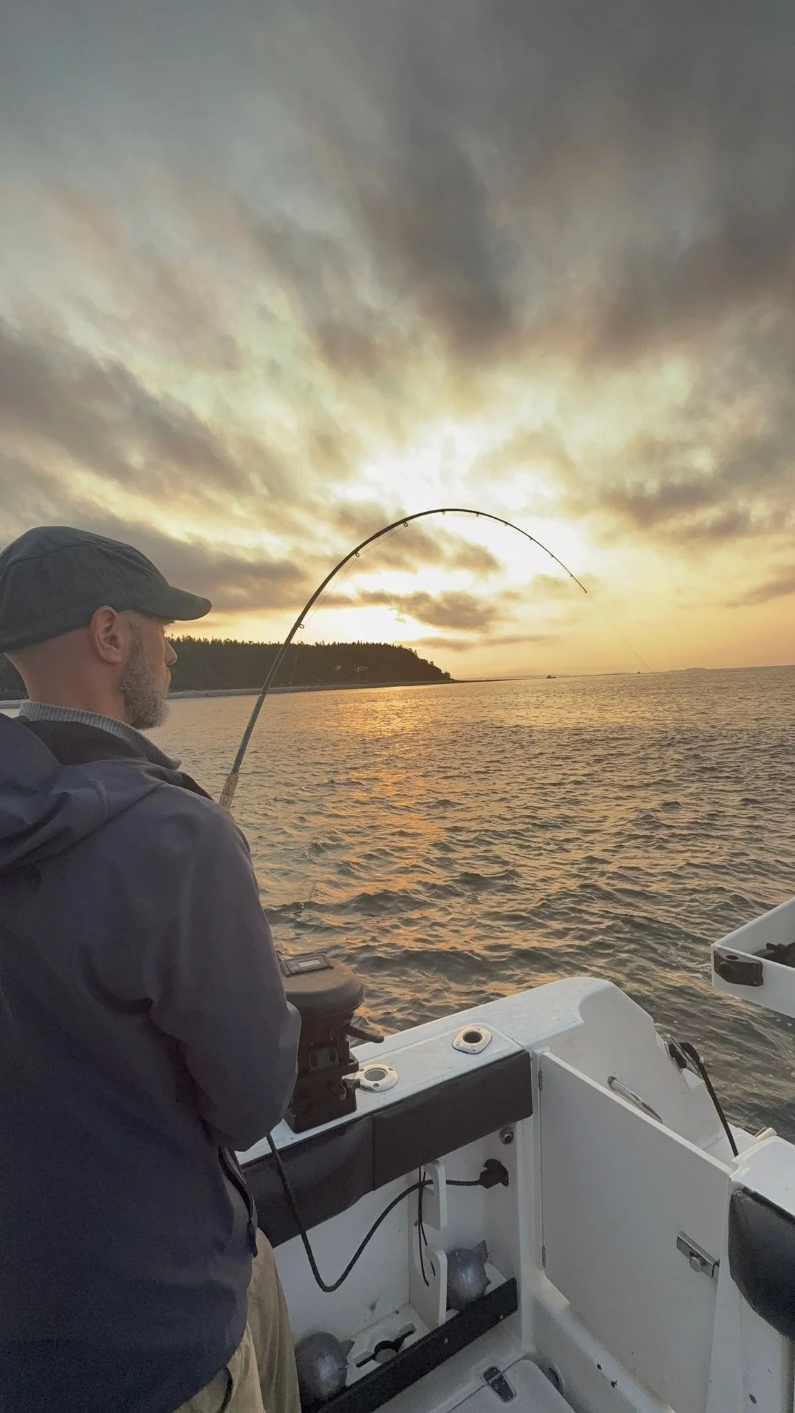 Angler Fighting Fish at Sunset